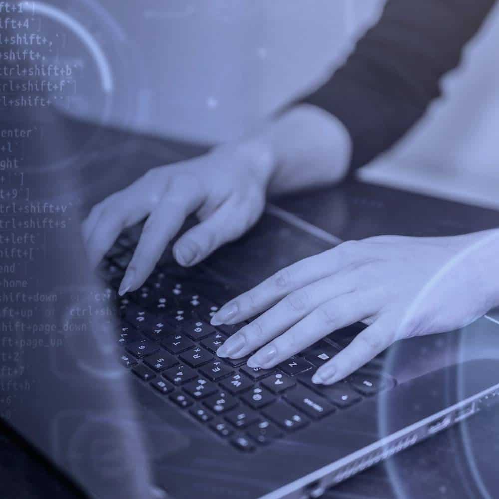 Cybersecurity Expert Working on Laptop Person using a laptop with cybersecurity code overlay for offensive security.
